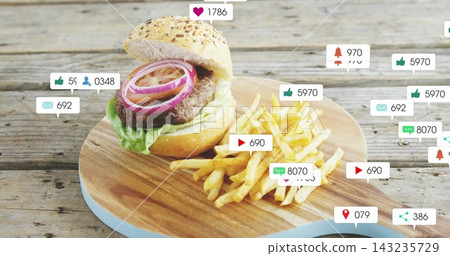 Showing sesame-bun burger and fries on round wood board, highlighting floating social media icons Showing sesame-bun burger and fries on round wood board, highlighting floating social media icons 143235729