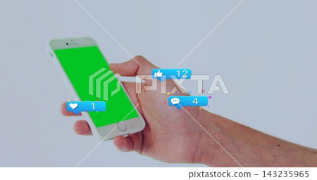 Holding right hand, bare arm showing white phone with green screen, pale backdrop, three alerts Holding right hand, bare arm showing white phone with green screen, pale backdrop, three alerts 143235965