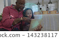 Pointing granddad red shirt guiding girl striped top headband holding tablet at home with hologram 143238117
