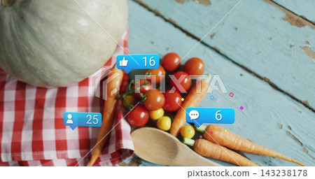Showing tabletop with cherry tomatoes, carrots, wooden spoon on turquoise table, badges 16 or 25 or  143238178