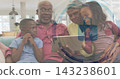 Gathering grandparents and grandchildren sitting on sofa at home, holding tablet with security HUD 143238601