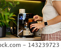 Woman preparing coffee at home near automatic coffee machine in coffee corner 143239723