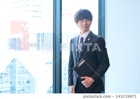 一位胸前佩戴徽章、面帶可靠微笑、職業男性的肖像。 一位胸前佩戴徽章、面帶可靠微笑、職業男性的肖像。 143239971