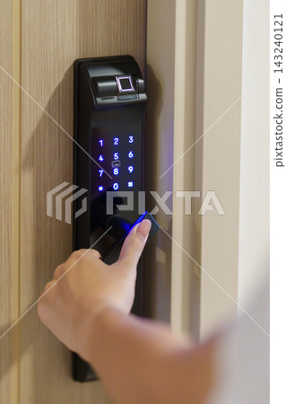 Hand using smart digital door lock while open or close the door at home or apartment. NFC Technology, Fingerprint scan, keycard, PIN number, smartphone, electrical and contactless lifestyle concepts Hand using smart digital door lock while open or close the door at home or apartment. NFC Technology, Fingerprint scan, keycard, PIN number, smartphone, electrical and contactless lifestyle concepts 143240121