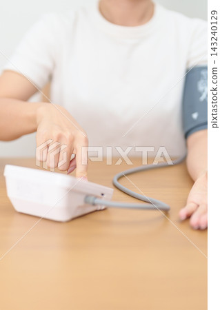 woman checking Blood pressure by Blood pressure monitor with Cuff. Systolic, SYS, Diastolic, DIA, Pulse, Hypertension, Hypotension, Heart rate, Cardiovascular Disease and May World hypertension day woman checking Blood pressure by Blood pressure monitor with Cuff. Systolic, SYS, Diastolic, DIA, Pulse, Hypertension, Hypotension, Heart rate, Cardiovascular Disease and May World hypertension day 143240129