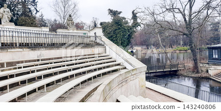 Stone spectator seating of the open-air Roman amphitheater in Lazienki Park, Warsaw - Warsaw, Poland - January 26, 2023 Stone spectator seating of the open-air Roman amphitheater in Lazienki Park, Warsaw - Warsaw, Poland - January 26, 2023 143240806