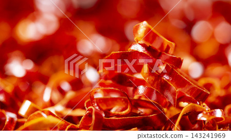 A close-up of bright red, glossy sliced chili peppers, showcasing the freshness of the ingredients. A close-up of bright red, glossy sliced chili peppers, showcasing the freshness of the ingredients. 143241969