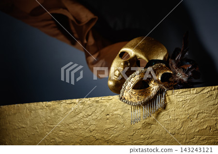 Golden carnival masks on a gold background. 143243121