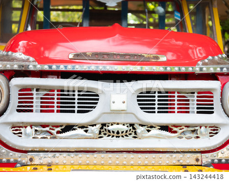 Close up front view of a vintage classic red passenger truck in Thailand. 143244418