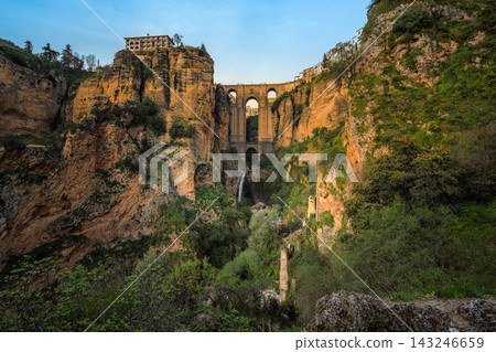 Puente Nuevo bridge and waterfall in El Tajo gorge seen from below, Ronda Puente Nuevo bridge and waterfall in El Tajo gorge seen from below, Ronda 143246659