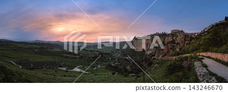 Dramatic limestone cliffs of Ronda with Puente Nuevo bridge at pink sunset Dramatic limestone cliffs of Ronda with Puente Nuevo bridge at pink sunset 143246670