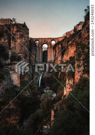 Puente Nuevo bridge spanning El Tajo gorge with waterfall in Ronda at dusk Puente Nuevo bridge spanning El Tajo gorge with waterfall in Ronda at dusk 143246693