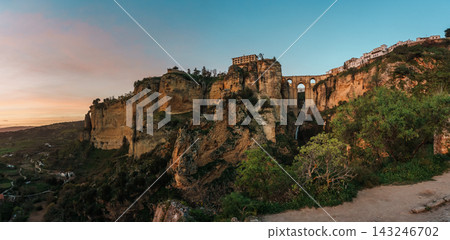 Puente Nuevo bridge spanning El Tajo gorge with waterfall in Ronda at dusk Puente Nuevo bridge spanning El Tajo gorge with waterfall in Ronda at dusk 143246702