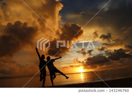 Human silhouettes floating on the sea at sunset Human silhouettes floating on the sea at sunset 143246760