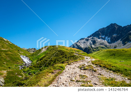Hiking trail through alpine meadow at Contamines Montjoie, France 143246764