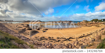 Sandy bay with granite reefs and tidal pools in Tregastel,France. Panoramic view Sandy bay with granite reefs and tidal pools in Tregastel,France. Panoramic view 143246784