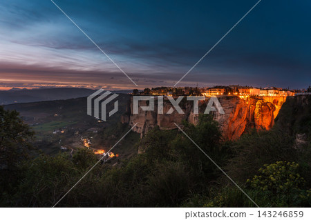 Illuminated clifftop town of Ronda above the valley at blue hour Illuminated clifftop town of Ronda above the valley at blue hour 143246859