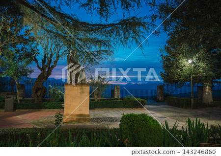 Seated statue in a tranquil garden overlooking mountains in Ronda at blue hour Seated statue in a tranquil garden overlooking mountains in Ronda at blue hour 143246860