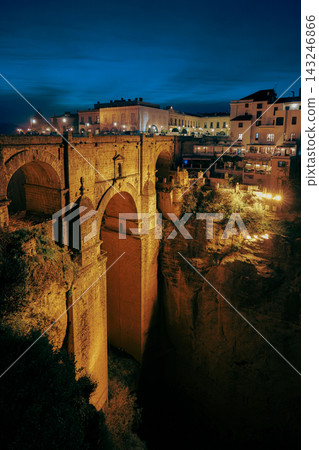 Illuminated Puente Nuevo bridge and clifftop buildings in Ronda at night Illuminated Puente Nuevo bridge and clifftop buildings in Ronda at night 143246866