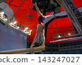 Female gymnast performing routine on balance beam 143247027