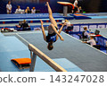 Female gymnast performing acrobatic flip 143247028