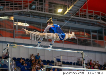 Female gymnast performing flight split Female gymnast performing flight split 143247031