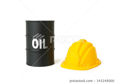 An oil barrel and a yellow construction hard hat. Oil field development, transport infrastructure. Raw material processing and engineering. An oil barrel and a yellow construction hard hat. Oil field development, transport infrastructure. Raw material processing and engineering. 143248000