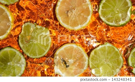 Top view of fresh lemon and lime slices floating in water Top view of fresh lemon and lime slices floating in water 143248341