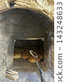 Traditional Bread Baking in Rustic Stone Oven. 143248633