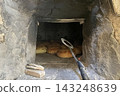 Traditional Bread Baking in Rustic Stone Oven. 143248639