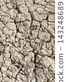 Dry Cracked Earth Soil Surface.Close-up view of arid, cracked earth suffering from severe drought and extreme climate conditions. 143248689