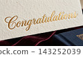 Extreme close up detail focusing on the luxurious texture of a gift card resting on a book cover 143252039