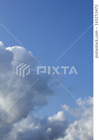 It is a blue sky with fluffy clouds. 143253472