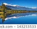 Beautiful lake Ianthe at the bottom of Southern Alps on The West Coast of South Island in New Zealand, mountains, forest, blue sky with reflection 143253533