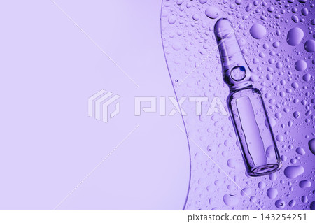 Ampoule with medicine or cosmetic product on wet transparent glass Ampoule with medicine or cosmetic product on wet transparent glass 143254251