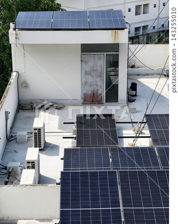 Rooftop solar panels installed on urban building 143255010