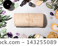 Spa Composition with Rolled Towels and Natural Wellness Accessories 143255089