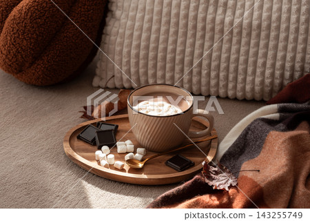 Cozy warm hot chocolate drink with marshmallows and dark chocolate squares on wooden tray Cozy warm hot chocolate drink with marshmallows and dark chocolate squares on wooden tray 143255749