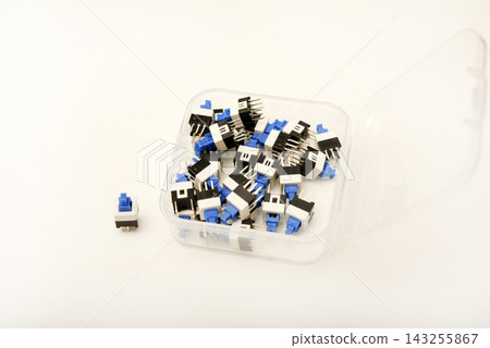 Plastic buttons in a box. Small buttons. Small buttons in electronics. 143255867