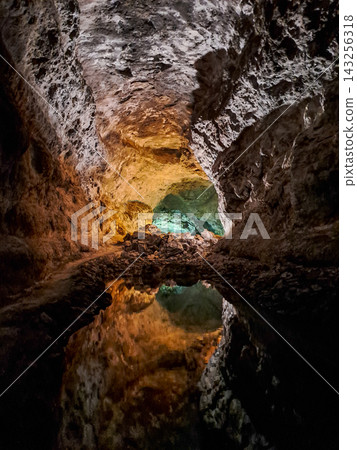 Perfect water reflection of an illuminated volcanic lava tube inside Cueva de los Verdes cave in Lanzarote, Canary Islands, Spain Perfect water reflection of an illuminated volcanic lava tube inside Cueva de los Verdes cave in Lanzarote, Canary Islands, Spain 143256318