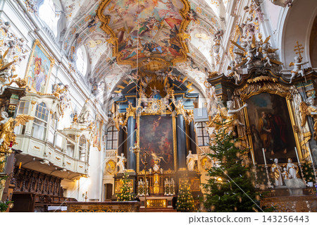 Interior of the baroque Basilica of Saint Emmeram with decorated Christmas trees during winter holiday season in Regensburg, Germany Interior of the baroque Basilica of Saint Emmeram with decorated Christmas trees during winter holiday season in Regensburg, Germany 143256443
