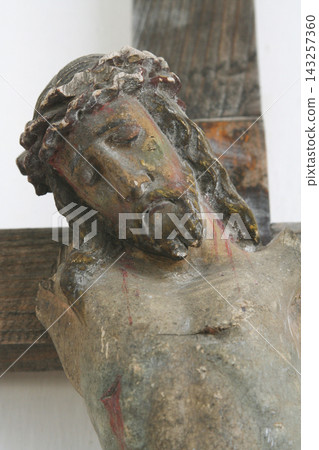 Close-up of an ancient wooden sculpture of Jesus Christ with crown of thorns Close-up of an ancient wooden sculpture of Jesus Christ with crown of thorns 143257360