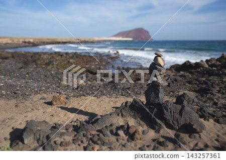 Stone cairn on a volcanic beach in Tenerife, Spain Stone cairn on a volcanic beach in Tenerife, Spain 143257361