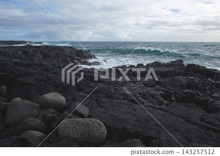 Dramatic volcanic cliffs and sea stack at Reykjanesviti coast in Iceland Dramatic volcanic cliffs and sea stack at Reykjanesviti coast in Iceland 143257512