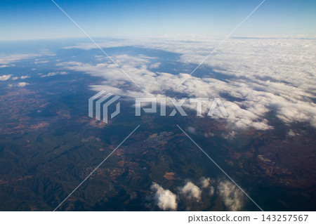 beautiful thick clouds in the sky from the height of the flight of the plane with a view of the continent and countries beautiful thick clouds in the sky from the height of the flight of the plane with a view of the continent and countries 143257567