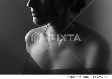 Black and white close up portrait of a pensive young girl 143257570