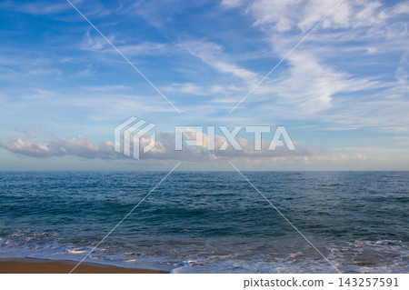 beautiful landscape on the coast of the beach and sea waves against the background of the blue sky beautiful landscape on the coast of the beach and sea waves against the background of the blue sky 143257591
