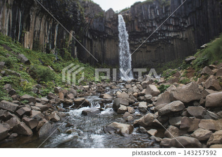 Svartifoss waterfall cascading over basalt columns in Skaftafell, Iceland Svartifoss waterfall cascading over basalt columns in Skaftafell, Iceland 143257592