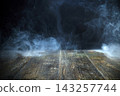 Smoke rising from rustic wooden surface creating mystery 143257744