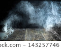 Smoke rising from rustic wooden surface background 143257746